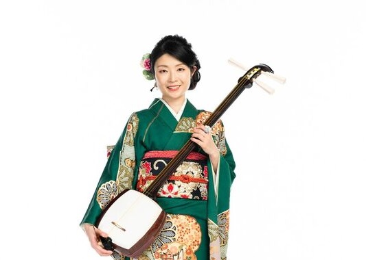 a woman in kimono holding a shamisen