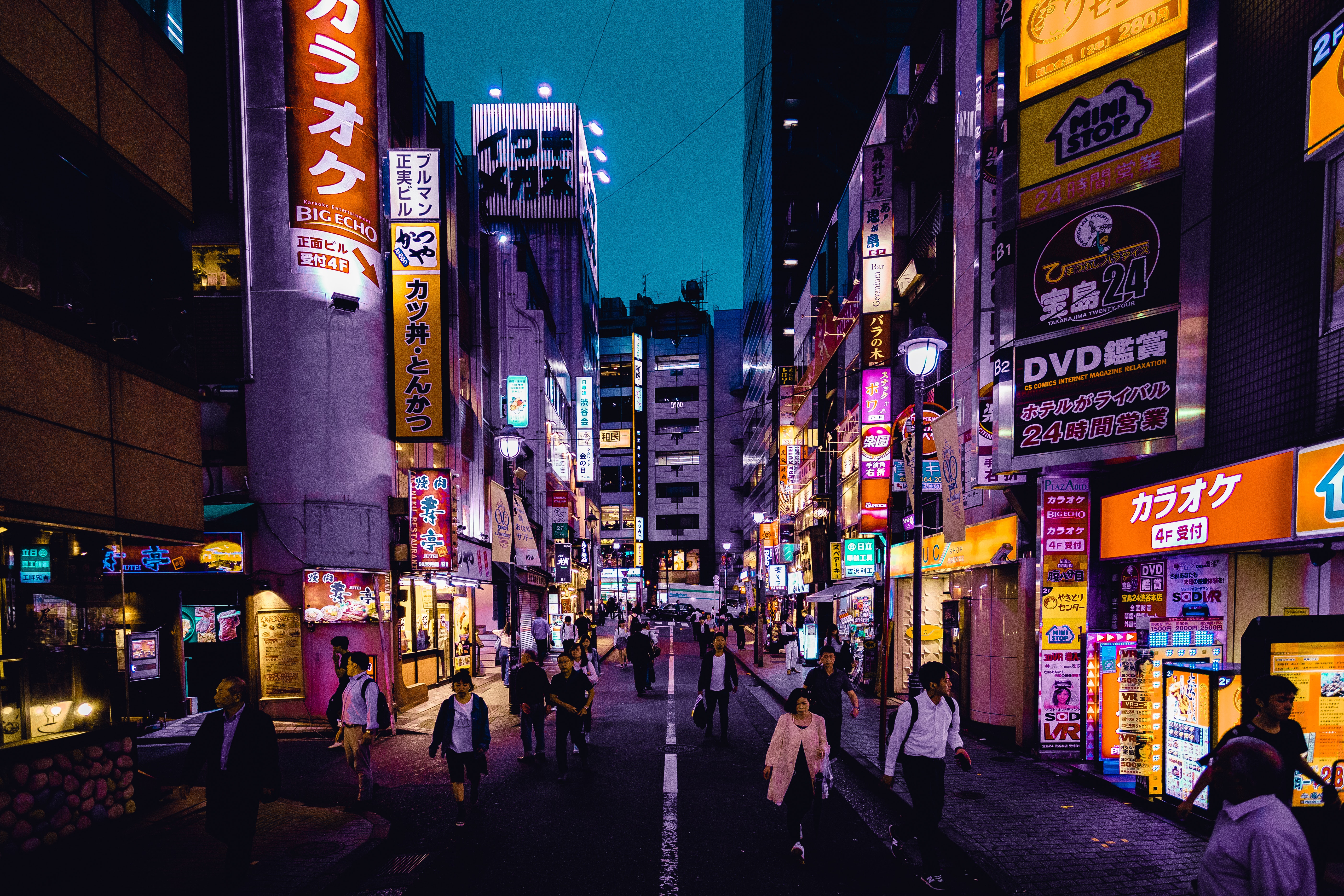 a city street in Japan featuring brightly lit signs